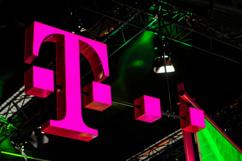 The logo of Deutsche Telekom, owner of T-Mobile, seen over a booth at the Mobile World Congress expo hall.