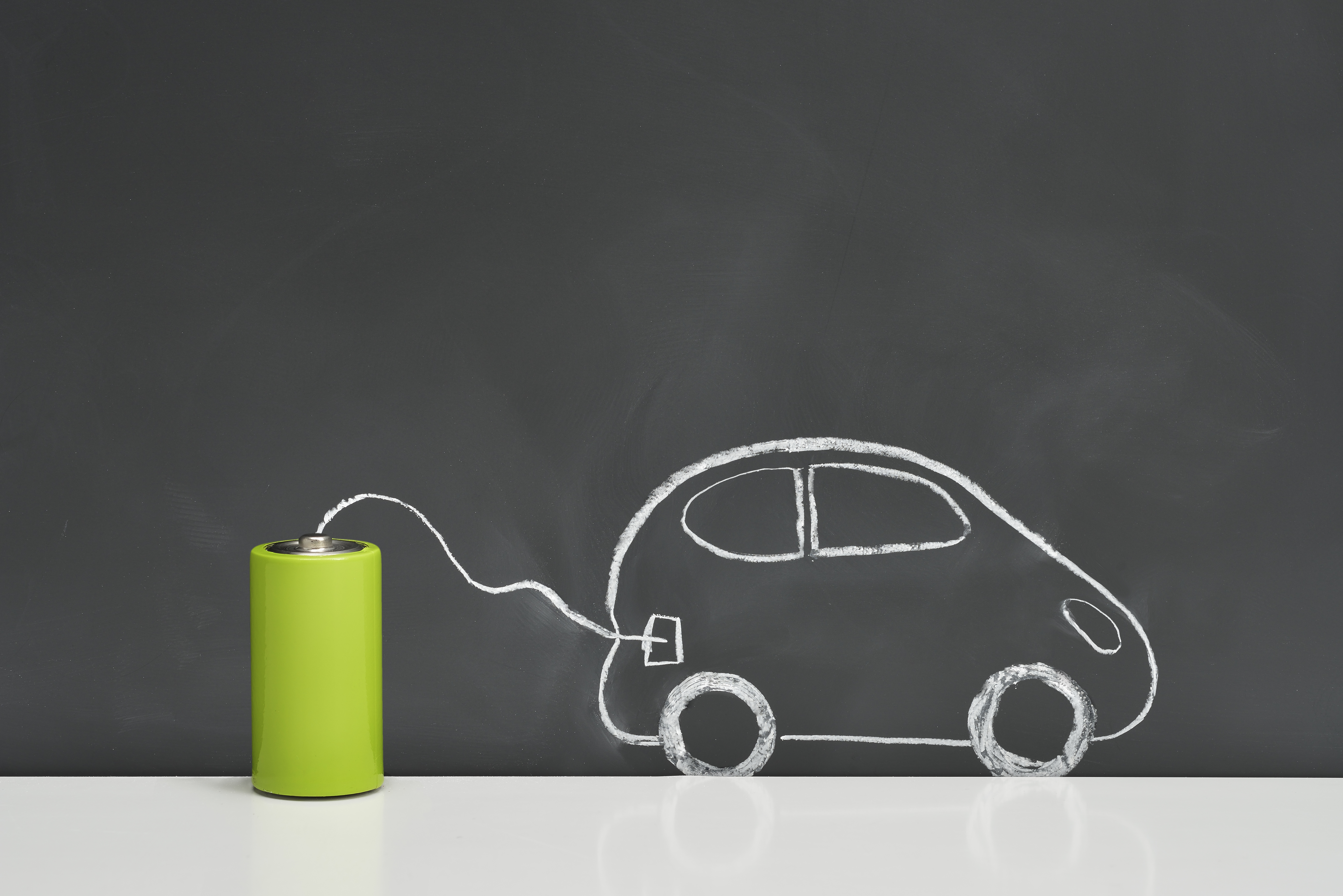 Batteries and electric vehicles on a blackboard