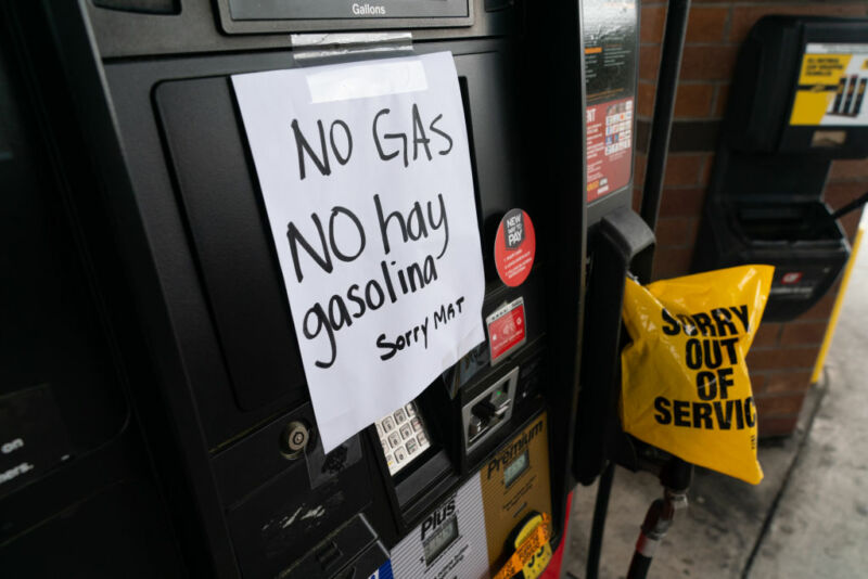 A paper sign reading no gas in both English and Spanish has been taped to a gasoline pump.