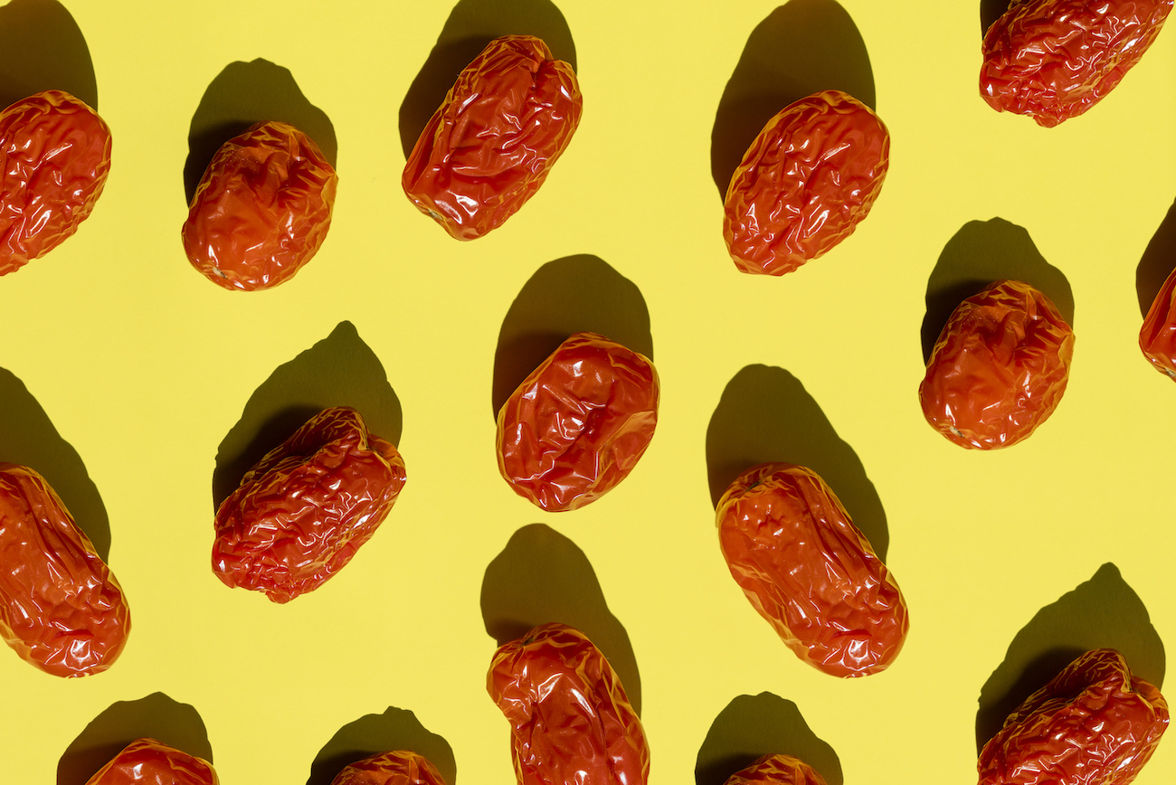 Directly above view of some rotten cherry tomatoes on Yellow background