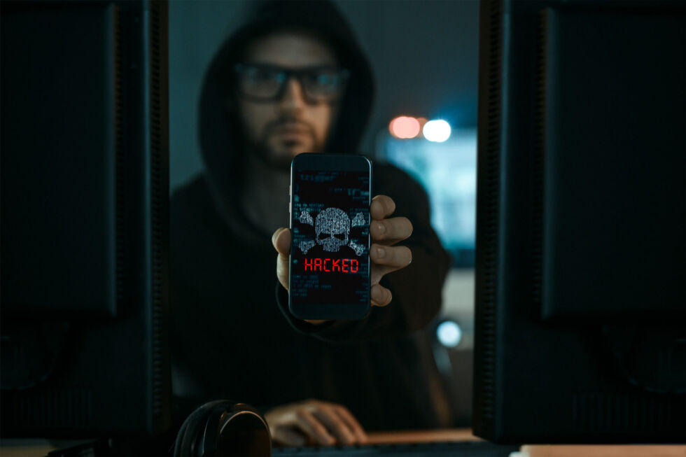 Artist's impression of a person who has hacked a mobile phone. (In reality, phones don't actually say "HACKED!" to alert you that you've been hacked. Things would be a lot easier if they did.)