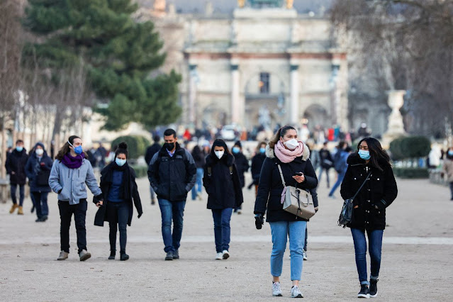 People wearing protective face masks walk in the Tuileries Gardens in Paris amid the coronavirus disease (COVID-19) outbreak in France,
