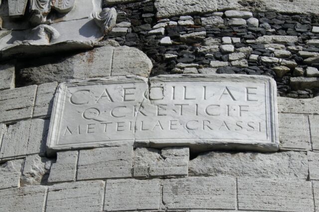 A plaque on the tomb reads "To Caecilia Metella, daughter of Quintus Creticus, [and wife] of Crassus".