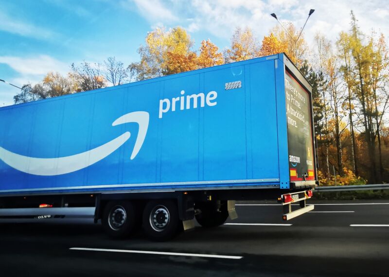A large Amazon Prime delivery truck driving on a highway.