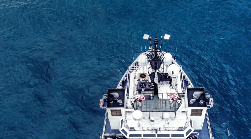 A large boat on the open sea equipped with two Starlink satellite dishes.