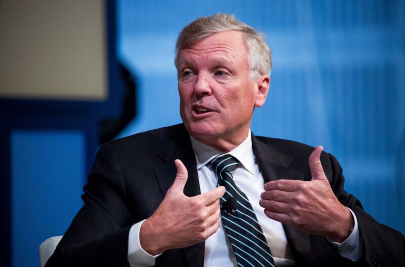 Charter CEO Tom Rutledge gesturing with his hands and speaking at a conference.