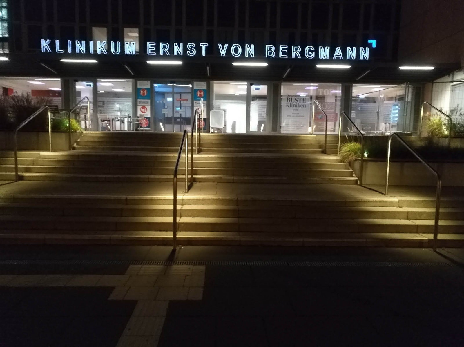 An outdoor stairway with dim lights illuminating it