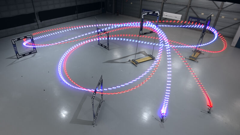 A long-exposure image of an AI-trained autonomous UZH drone (the blue streak) that completed a lap half a second ahead of the best time of a human pilot.