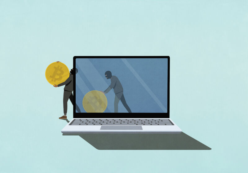 photo illustration of Cyber thieves stealing Bitcoin on laptop screen